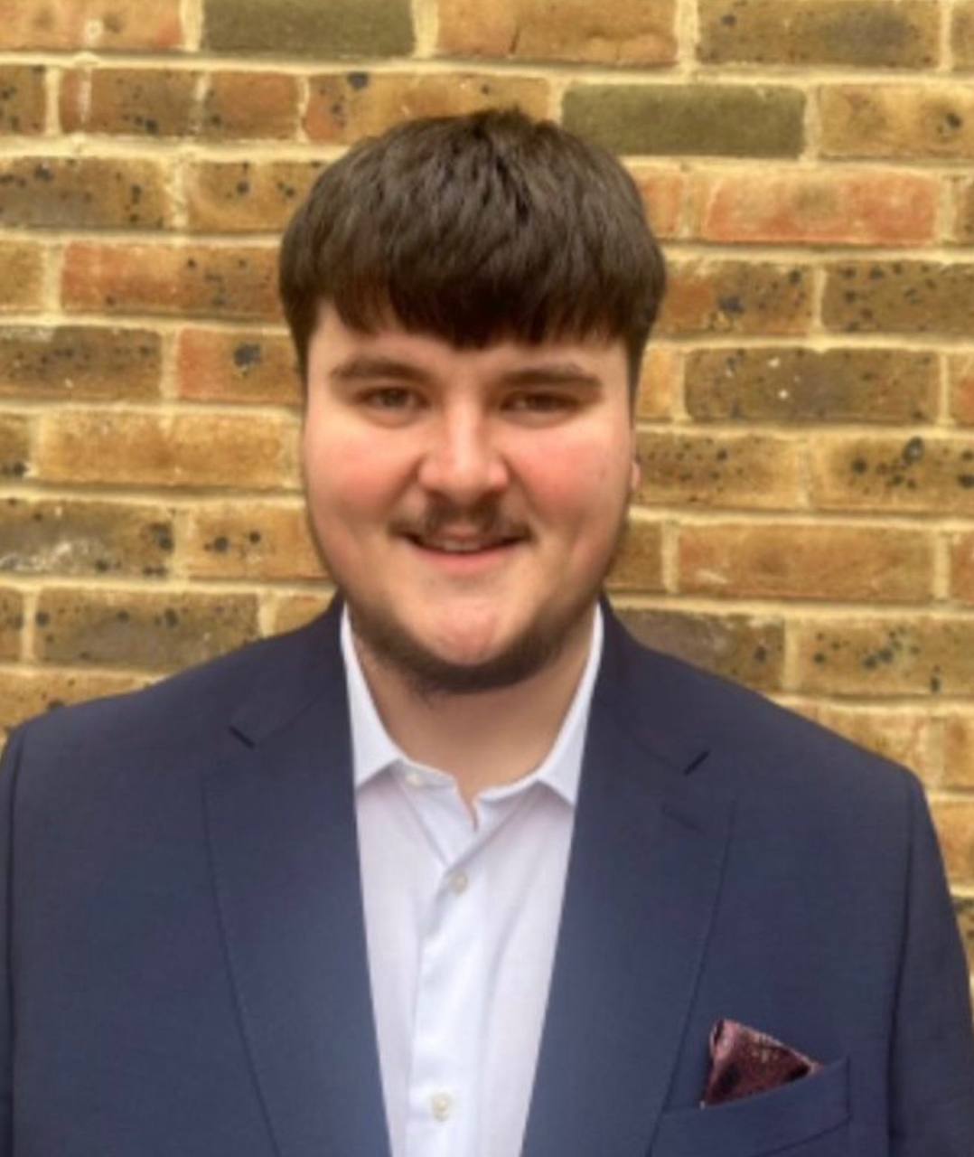Will Freeman, founder of Close Rate UK, head and shoulders in a navy suit, looking at the camera